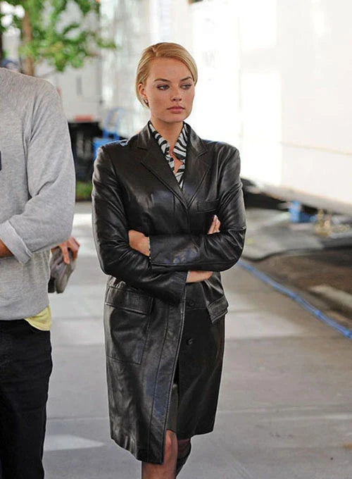 Back view of a knee-length black leather coat with a sleek tailored design.